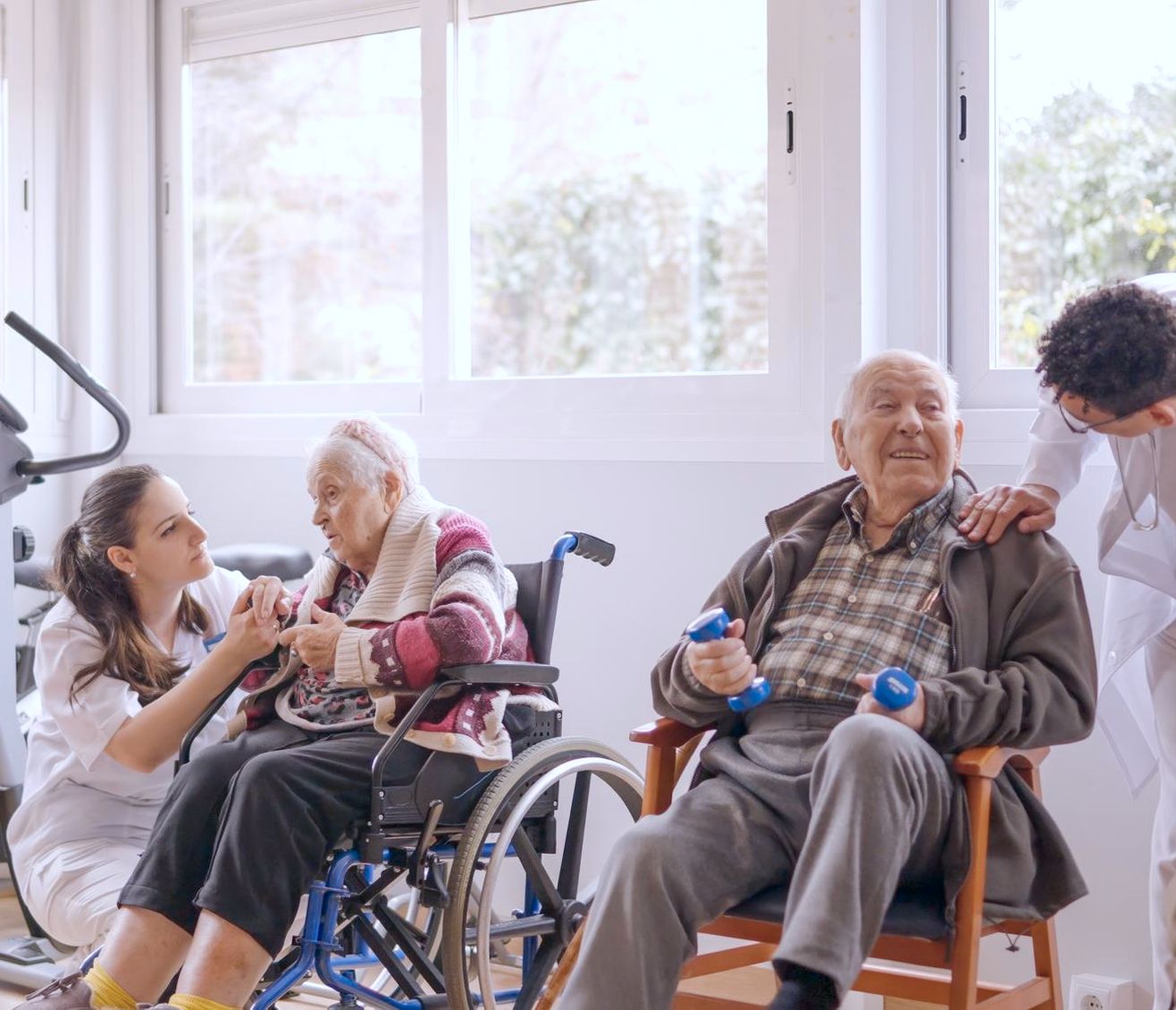 Two adults, one in a wheelchair, in an exercise group