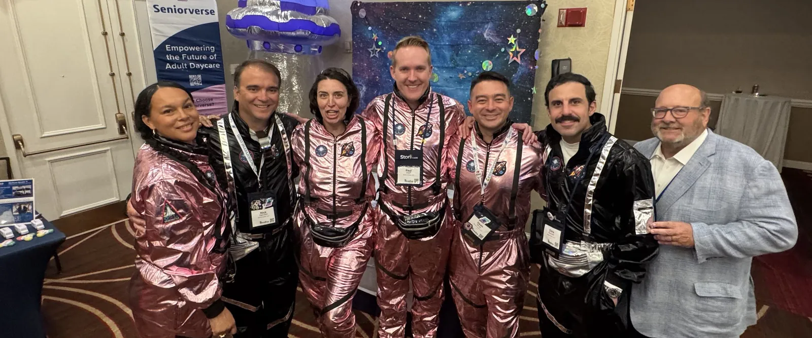 The Seniorverse team in matching space suits at their conference booth